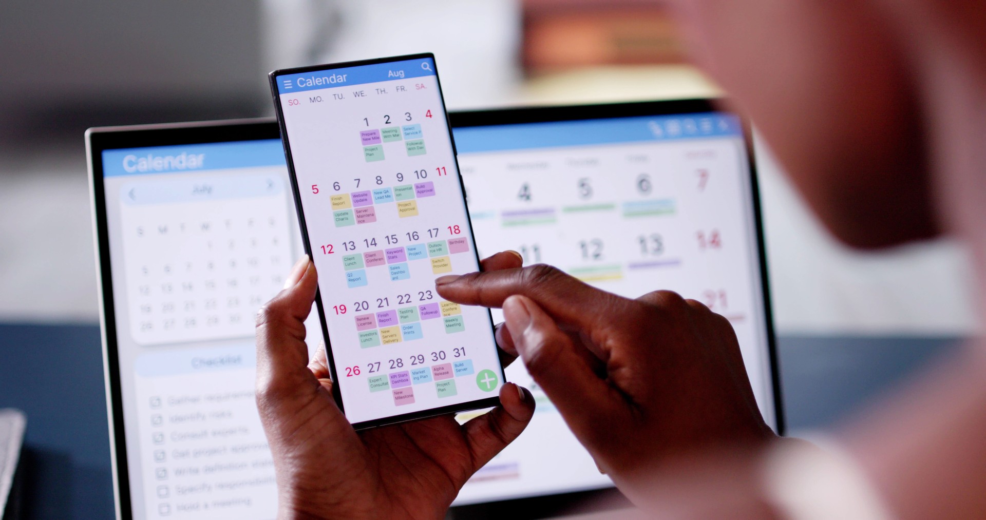 African Woman Organizing Appointment Schedule Using Cellphone And Calendar