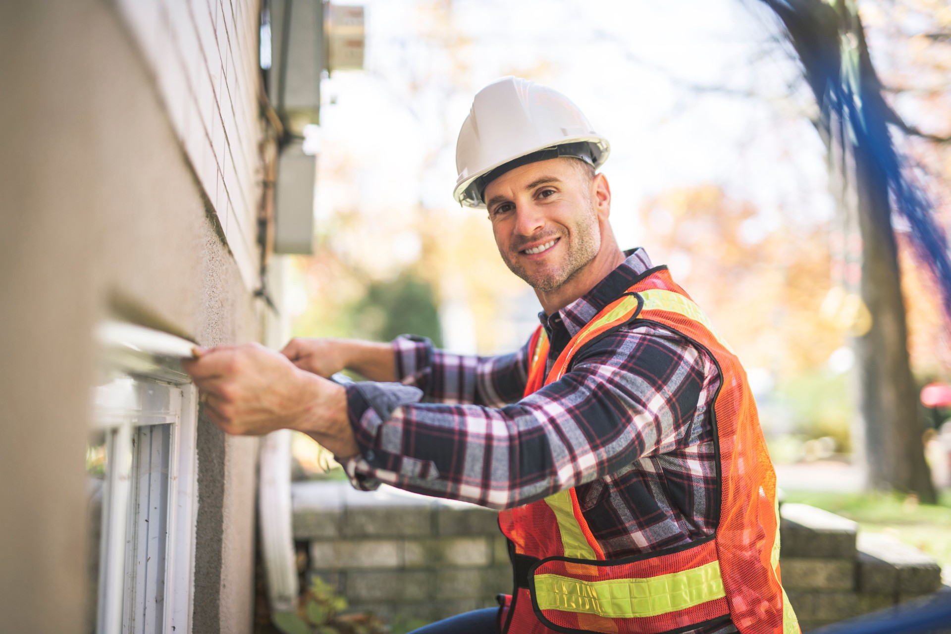 Man inspecting house window outside on day light