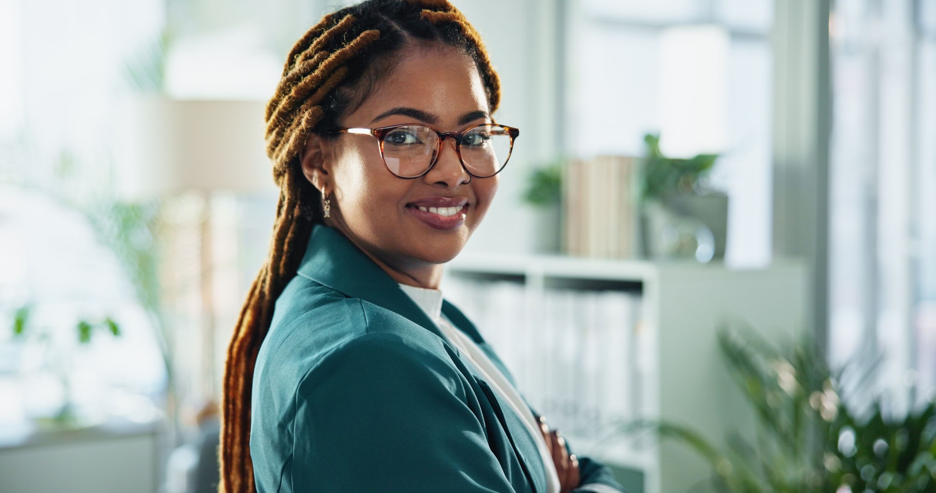 Happy, confident and portrait of businesswoman in office with positive attitude for legal career. Smile, glasses and face of professional African female attorney with pride for law case in workplace.