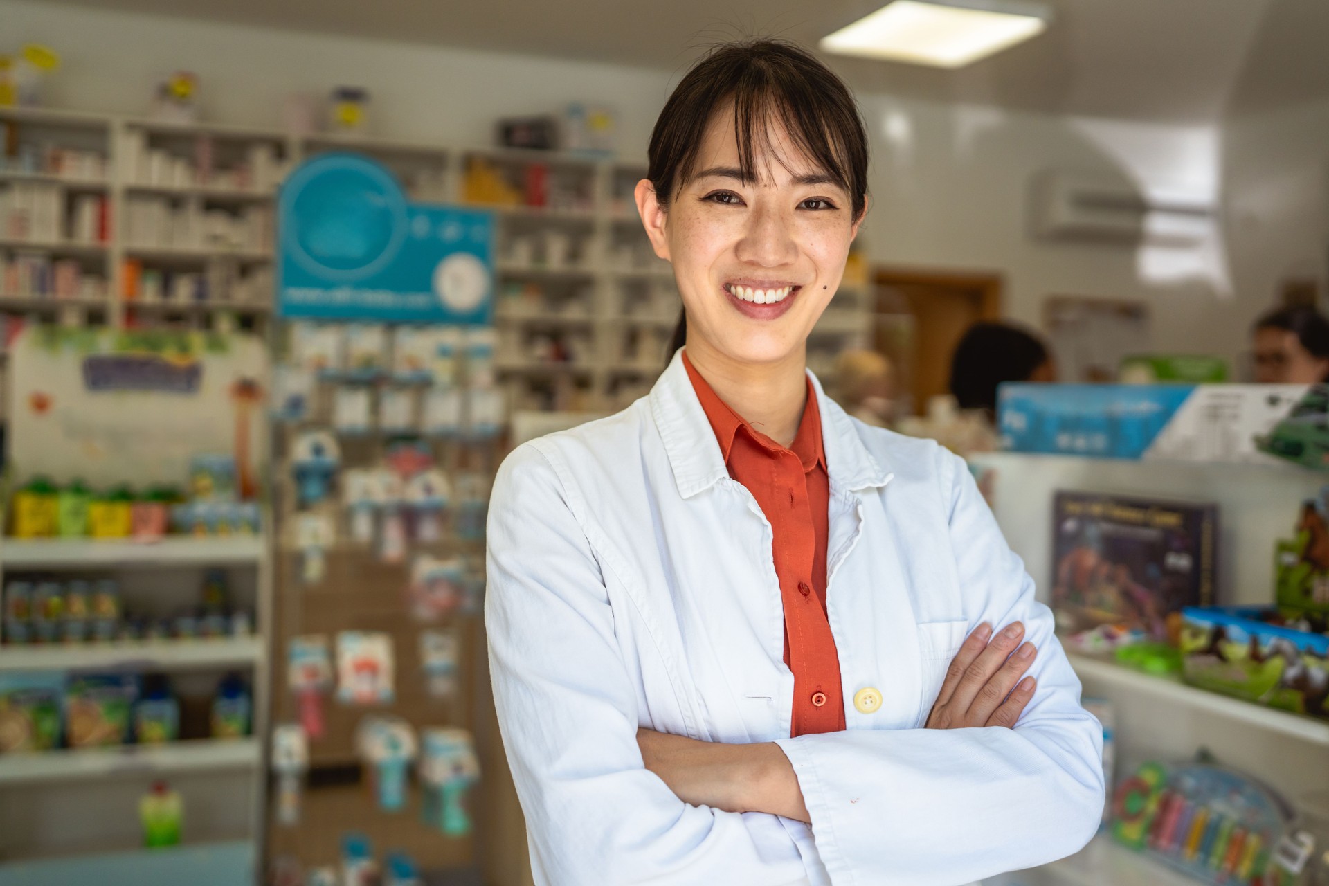 Smile japanese pharmacist is posing in a pharmacy shop
